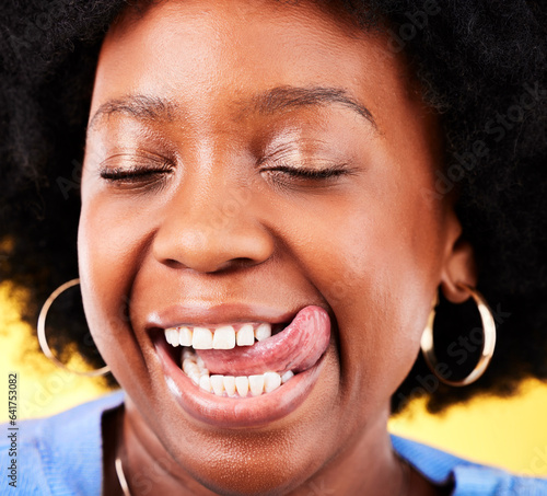 Fotografie Tongue out, comic and closeup of black woman on a yellow background for happiness or crazy