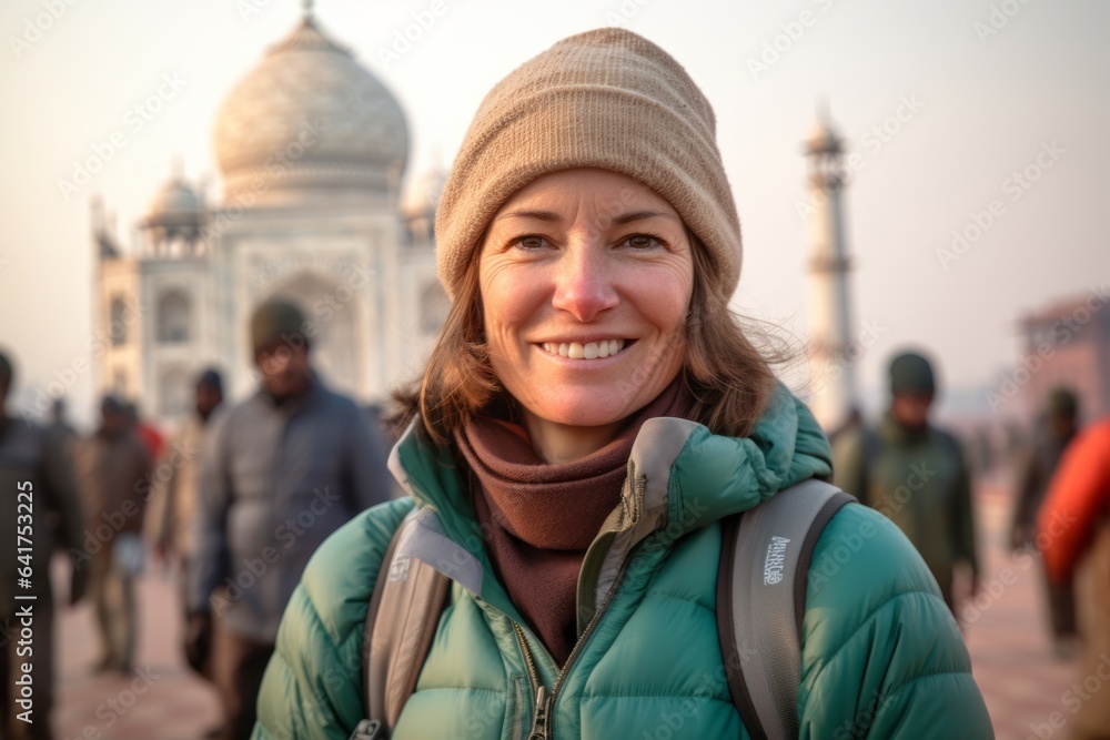 Medium shot portrait photography of a glad girl in her 40s wearing a durable down jacket in front of the taj mahal in agra india. With generative AI technology Medium shot portrait photography of a glad girl in her 40s wearing a durable down jacket in front of the taj mahal in agra india. With generative AI technology
