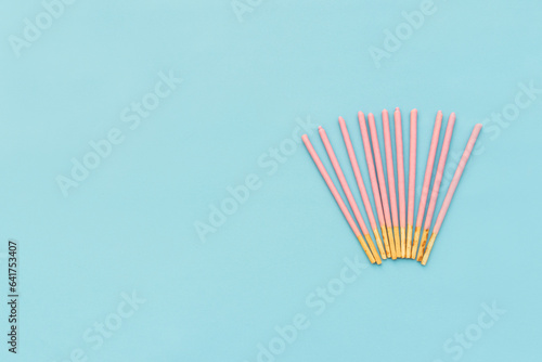 Pocky biscuits isolated on blue background, after some edits. photo