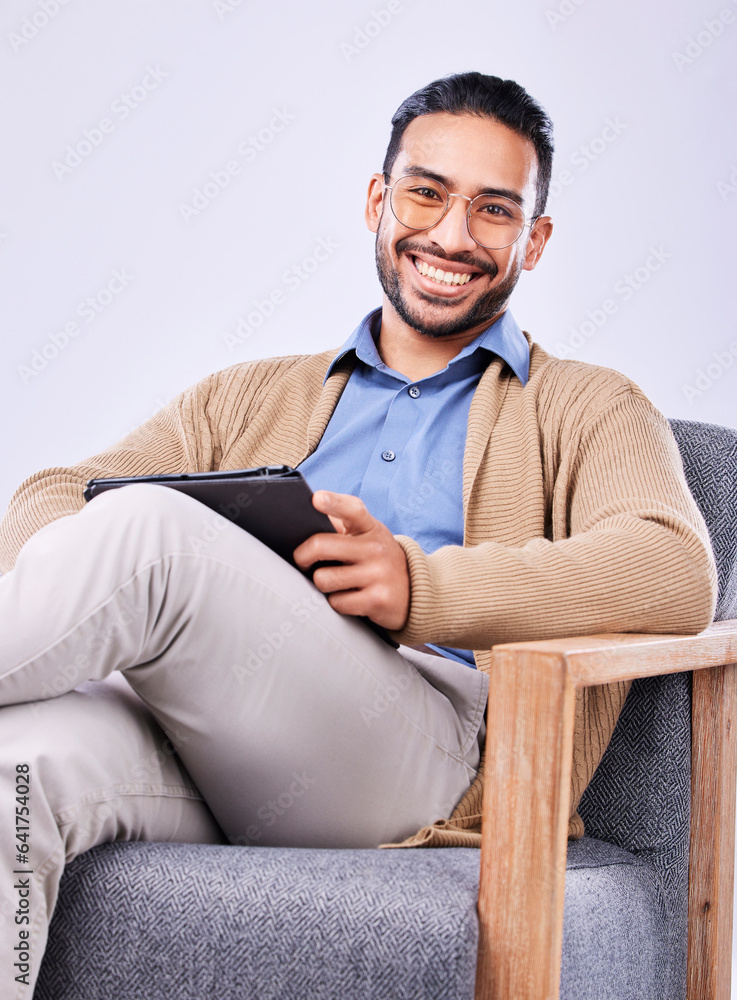 Portrait, tablet and psychology with a man in a chair on a white background in studio to listen for diagnosis. Psychologist, mental health and smile with a happy person counseling during therapy