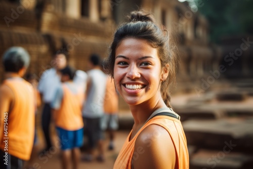 Close-up portrait photography of a satisfied girl in her 20s wearing a high-performance basketball jersey at the angkor wat in siem reap cambodia. With generative AI technology