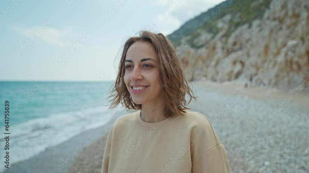 Outdoor portrait beautiful summer woman walking pebble beach and enjoying weekend at seaside with cliffs by the sea coast. Outdoor portrait beautiful summer woman walking pebble beach and enjoying weekend at seaside with cliffs by the sea coast.