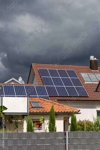 new building with solar panel on rooftop and garden green tree bush with cloudy sky weather