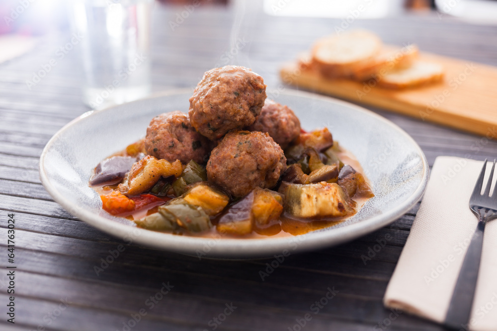 Cooked meatballs with stewed eggplant with haze in bowl
