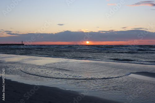 Scenic sunset over the sea. Calm Baltic sea. Poland seaside  Leba village and beach. Seascape