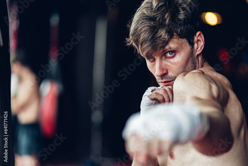 Boxer training in Boxing Club. Boxing fighters training at gym. Strong muscular Man practicing box in gym. © kanpisut