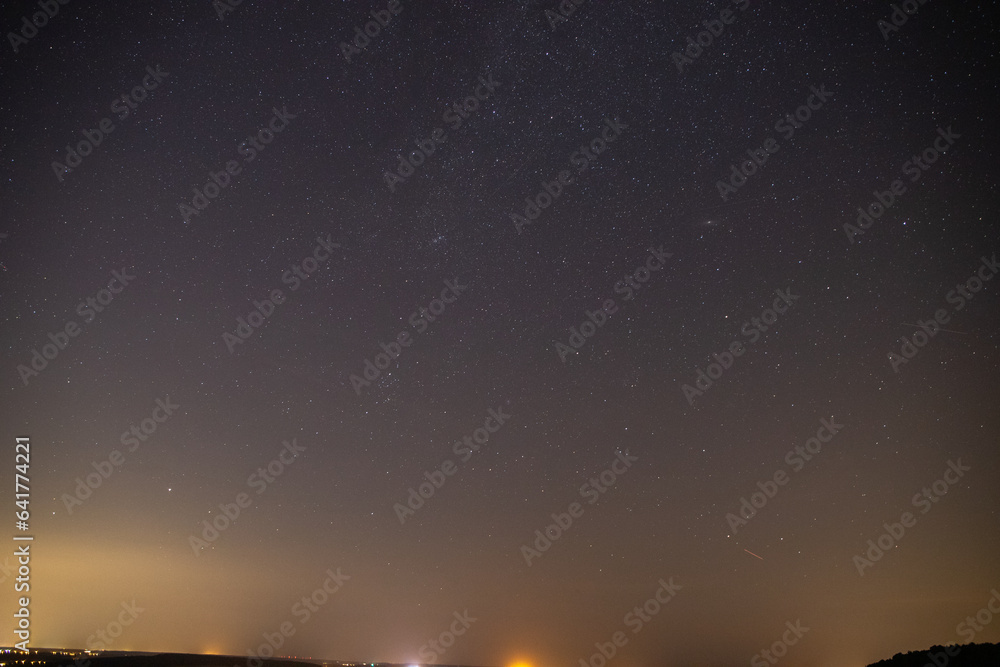 Stars sky with Milky Way in front of a forest