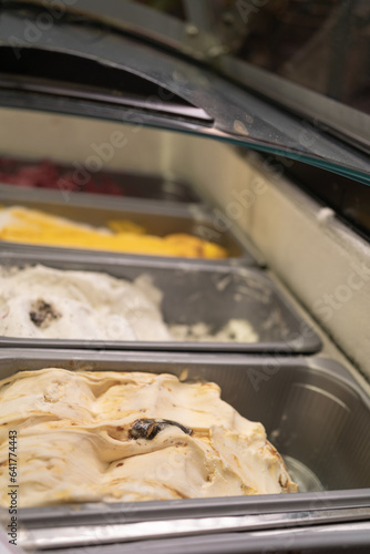 Traditional Italian artisan ice cream gelato at showcase in the fridge