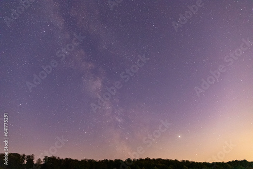 Stars sky with Milky Way in front of a forest