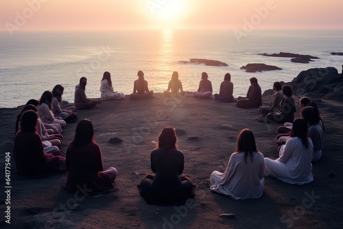 Group of Women practicing mindfulness in a circle near the ocean. top view with copy space and sunrise in the background
