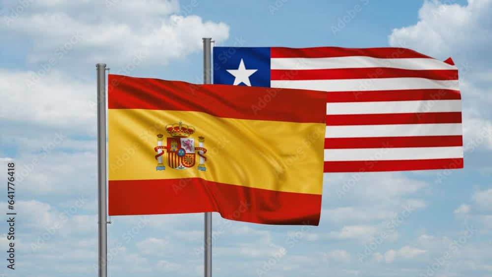 Liberia and Spain flag waving together in the wind on blue sky, cycle looped video, two country cooperation concept Liberia and Spain flag waving together in the wind on blue sky, cycle looped video, two country cooperation concept
