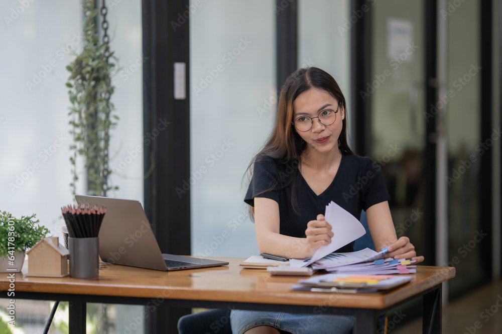 Freelance businesswoman preparing documents. Check and review the marketing plan. Freelance businesswoman preparing documents. Check and review the marketing plan.