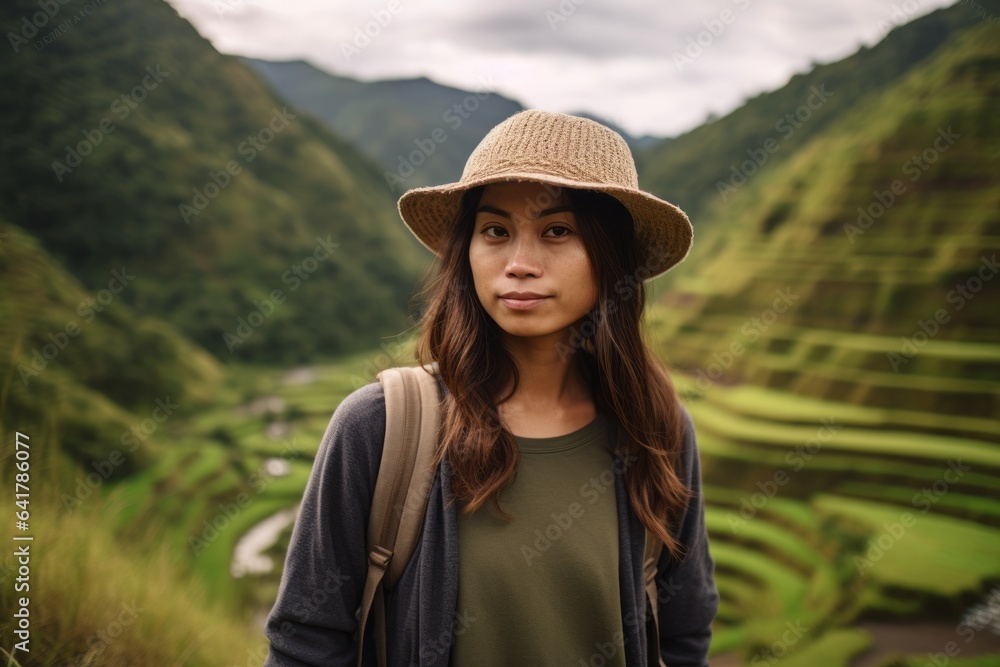 Medium shot portrait photography of a content girl in her 30s wearing a casual baseball cap at the banaue rice terraces in ifugao philippines. With generative AI technology