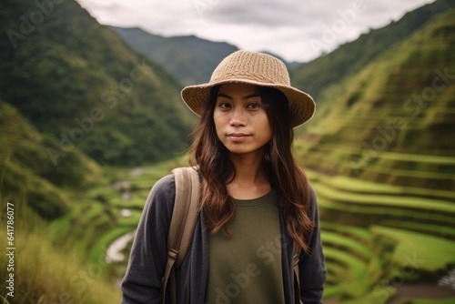 Medium shot portrait photography of a content girl in her 30s wearing a casual baseball cap at the banaue rice terraces in ifugao philippines. With generative AI technology