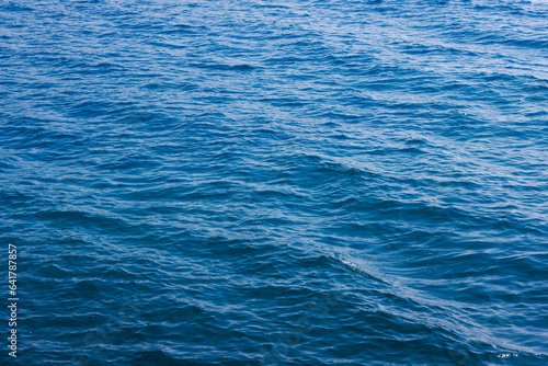 generic boundless sea water surface, only blue water at day time with mild ripple vawes
