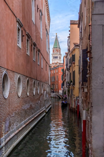 Narrow canal with old colorful houses in Venice, Italy 
