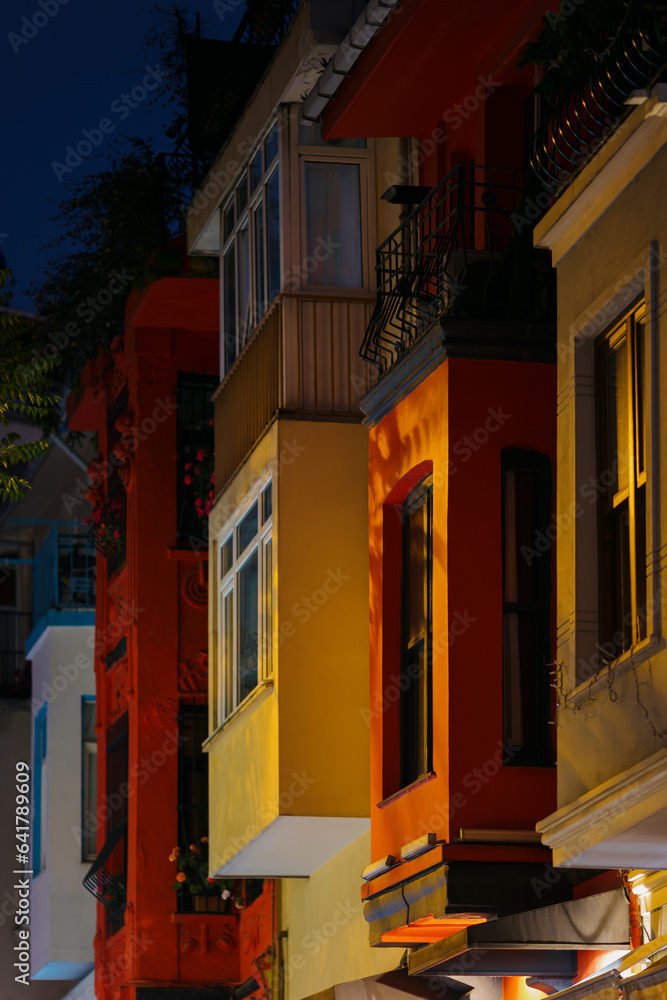 Rows of orange, yellow, red and white balconies at night