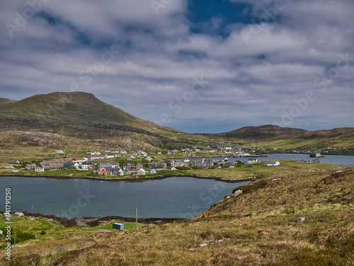 The village of Castlebay on the island of Barra in the Outer Hebrides, Scotland, UK. Taken looking northeast with the hill of Heaval, the highest point on Barra in the background. photo