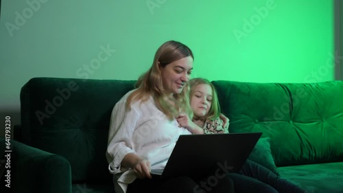 a young woman works at home, the children run into the frame and have fun, distracting the mother from work