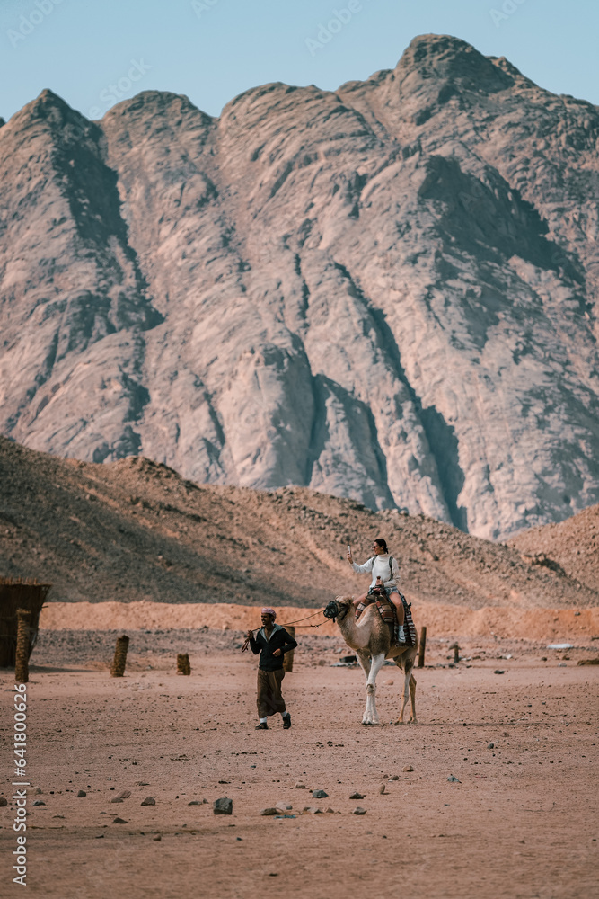Riding a Camel, Desert Landscape with Mountains