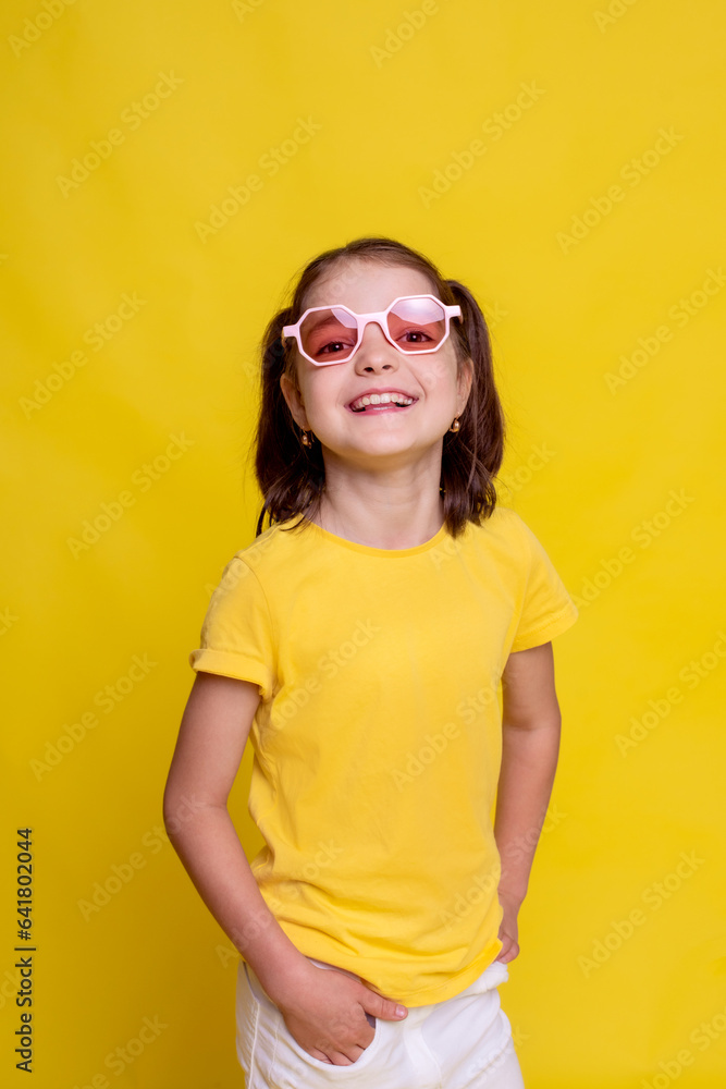 child girl in mockup yellow T-shirt on yellow background. summer banner crazy seasonal sale of children clothes child girl in mockup yellow T-shirt on yellow background. summer banner crazy seasonal sale of children clothes