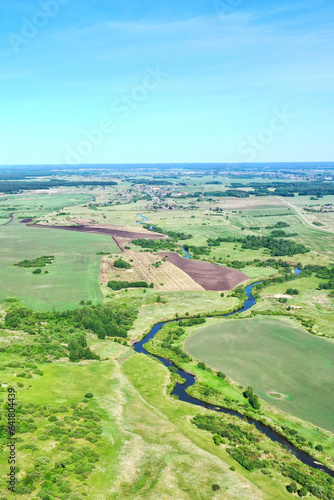 Panorama from height to winding river and summer fields with bushes and trees. Flight over the countryside © ArtEvent ET
