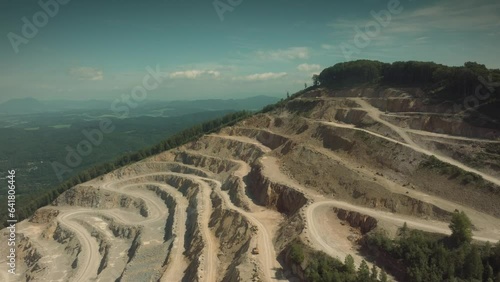 Epic drone shot of a quarry in the middle of the sunny day.