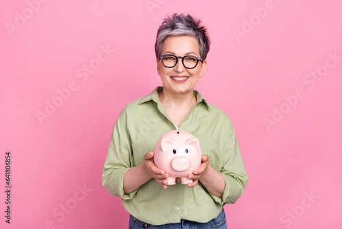 Slika na platnu Photo of positive successful businesswoman elderly wear trendy khaki shirt hold