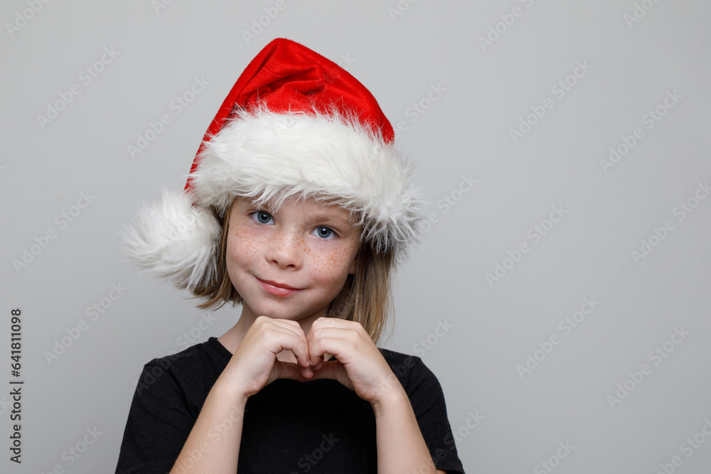 Happy Christmas child girl showing heart from her hands, Xmas portrait Happy Christmas child girl showing heart from her hands, Xmas portrait