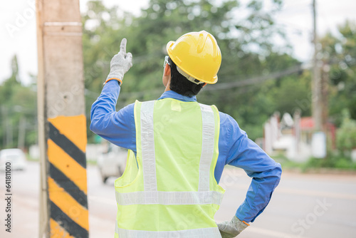 Mechanical engineer inspecting work on electrical pole The mechanic is doing unfinished work.
