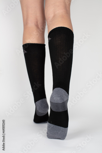 legs in black stockings walking away, sock on