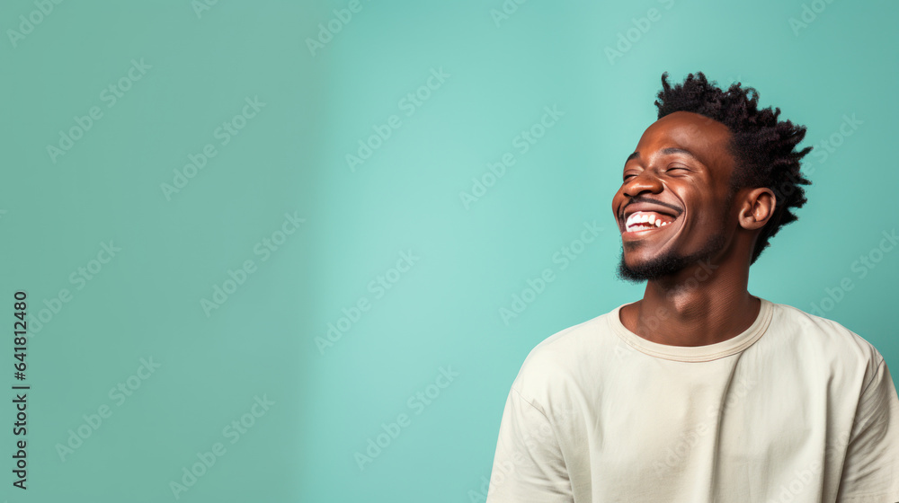 African male smiling on the pastel background African male smiling on the pastel background