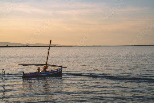 Catalan boat at the sunset photo