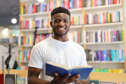 A young man immersed in learning at a library, surrounded by books and knowledge.