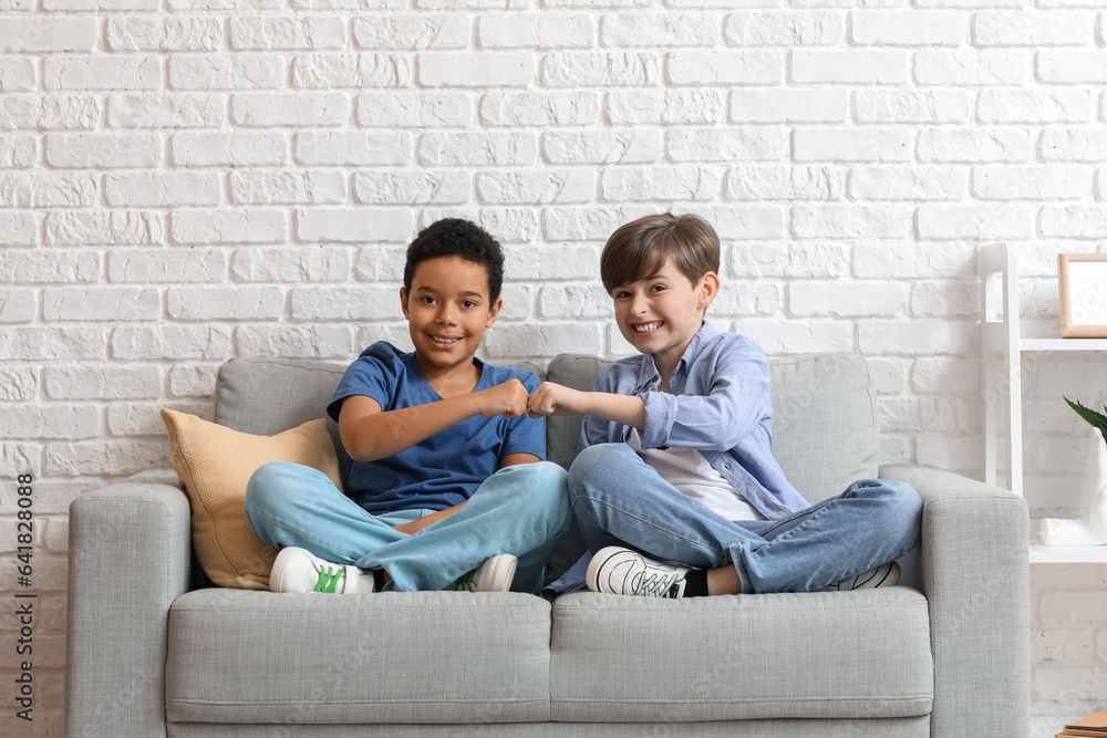 Cute little boys bumping fists at home Cute little boys bumping fists at home