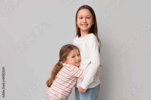 Cute little sisters hugging...