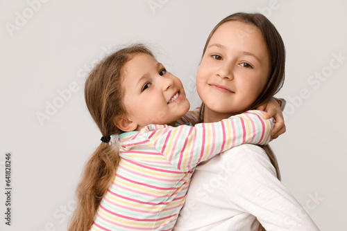 Cute little sisters hugging...