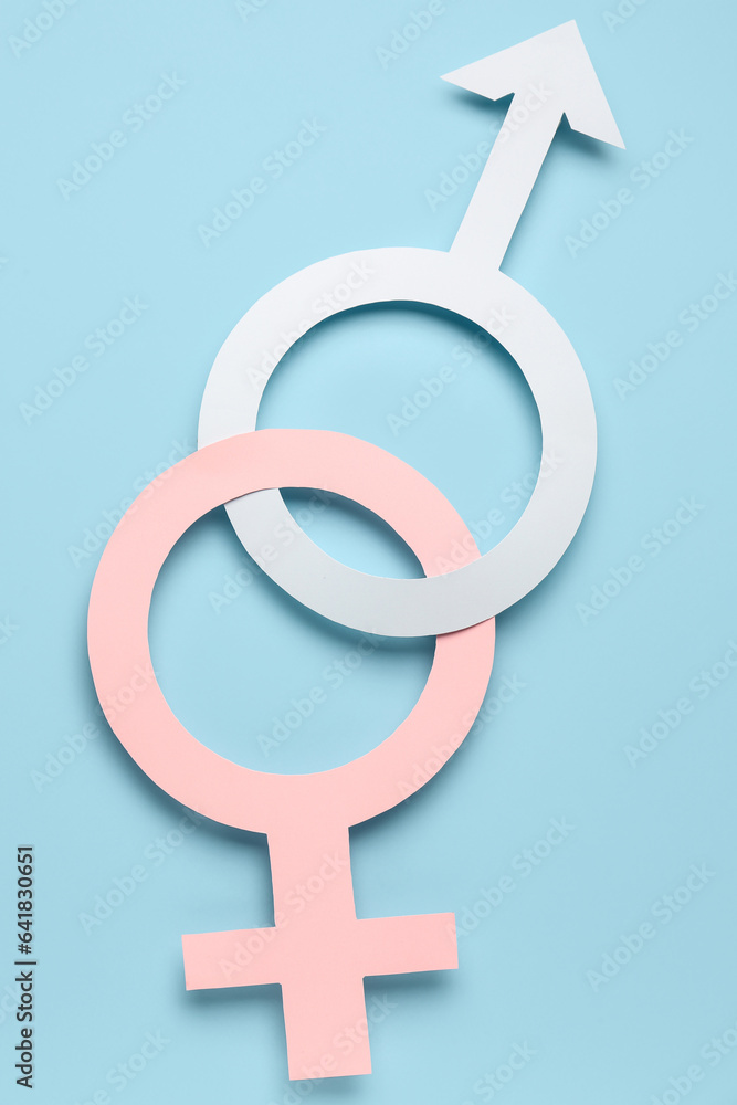 Paper symbols of female and male on blue background Paper symbols of female and male on blue background