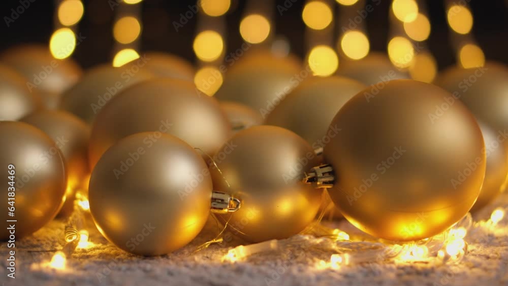 Golden Christmas tree decorations for Christmas and New Year. The light glitter in bokeh mode turns your video's background into a magical light skate for holiday looks and decorations. Golden Christmas tree decorations for Christmas and New Year. The light glitter in bokeh mode turns your video's background into a magical light skate for holiday looks and decorations.