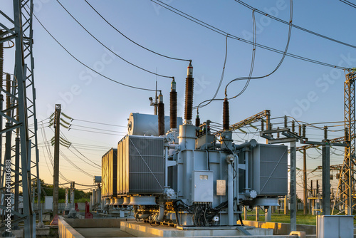 High voltage transformer in the rays of the morning sun. the result of shooting in the direction of sunrise.