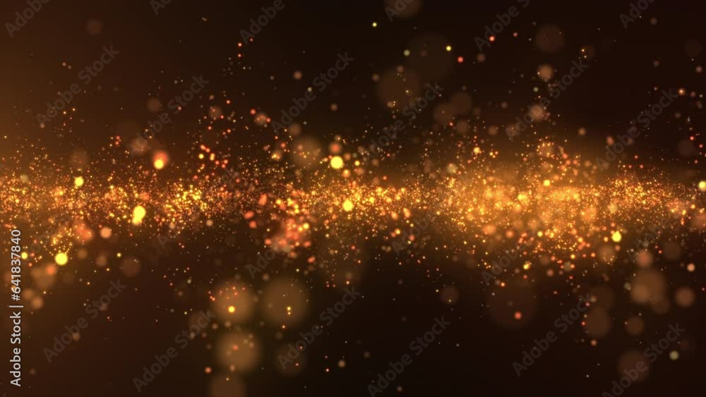 Golden shining particles slowly flowing on dark background with soft ...