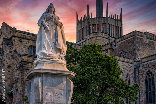 Blackburn Cathedral with Queen Victoria Statue at Sunset.  The statue is a Grade II listed monument located at Blackburn, Lancashire, UK.