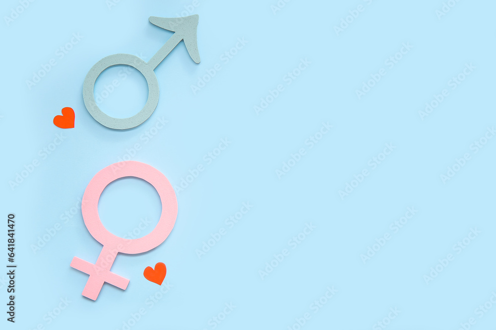 Female and male gender symbols and hearts on blue background Female and male gender symbols and hearts on blue background