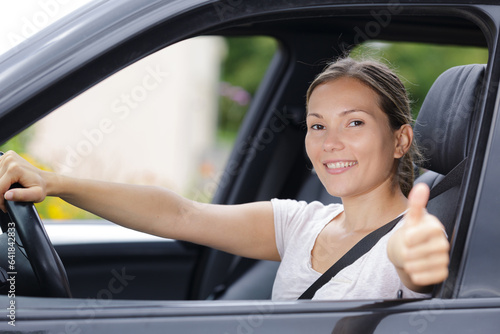 female driver showing thumbs up © auremar