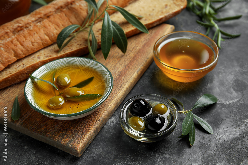 Bowls of fresh olive oil on black background Bowls of fresh olive oil on black background