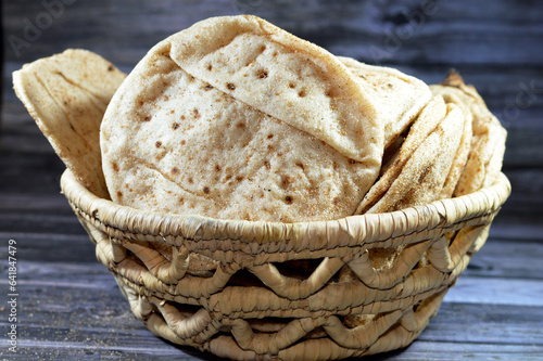Traditional Egyptian flat bread with wheat bran and flour, regular Aish Baladi or Egypt bread baked in extremely hot ovens, it is the result of a mixture of wheat flour, yeast, salt and water