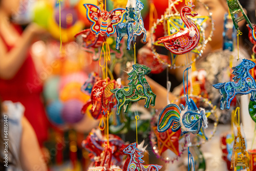 Decorated colorful lanterns hanging on a stand in the streets in Ho Chi Minh City, Vietnam during Mid Autumn Festival. Chinese language in photos mean money and happiness