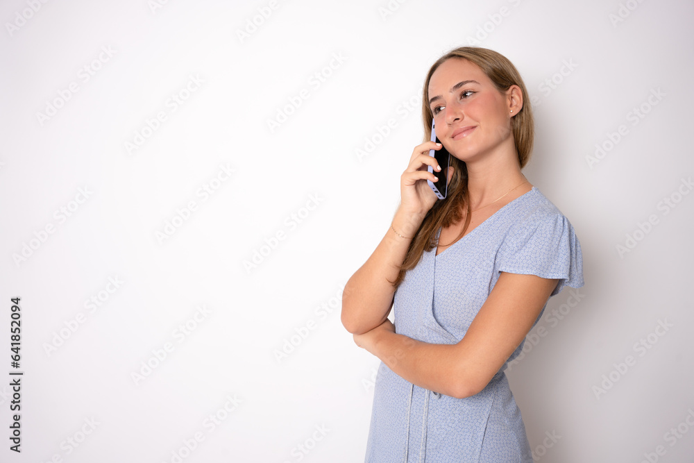 Closeup portrait of young, happy beautiful woman talking on cell phone looking away, over white background Closeup portrait of young, happy beautiful woman talking on cell phone looking away, over white background