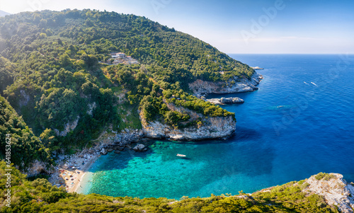 The remote beach of Fakistra, North Pelion mountain, Greece, with emerald shining sea and thick pine forest © moofushi