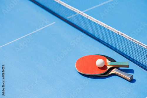 tennis rackets for playing ping pong on blue table, ping pong concept photo